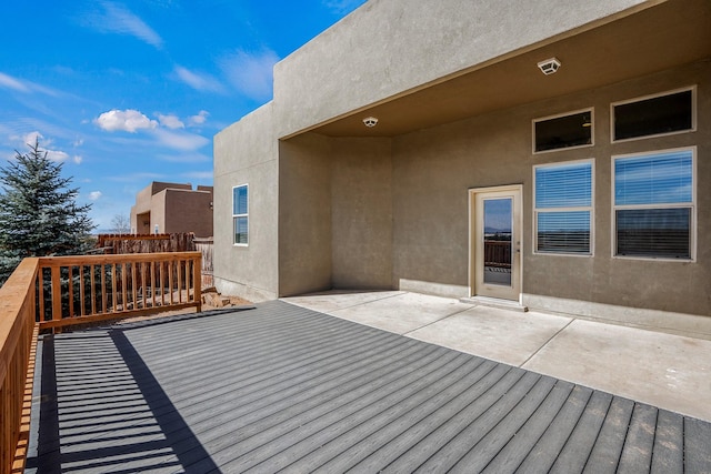 wooden deck with a patio