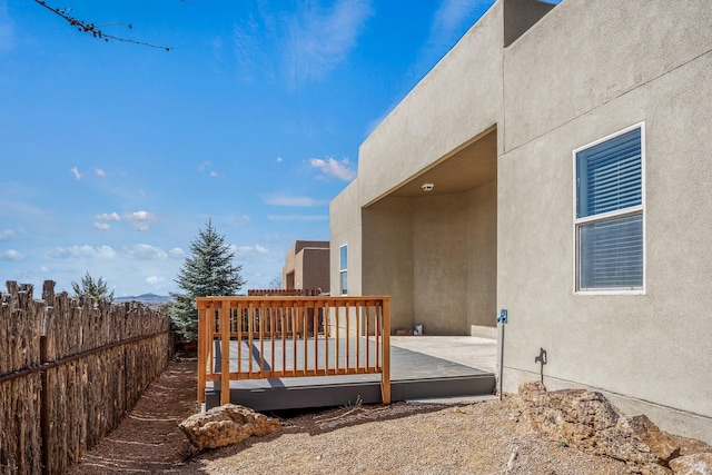 view of yard with a wooden deck and fence