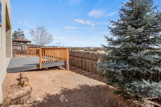 view of yard with fence and a wooden deck