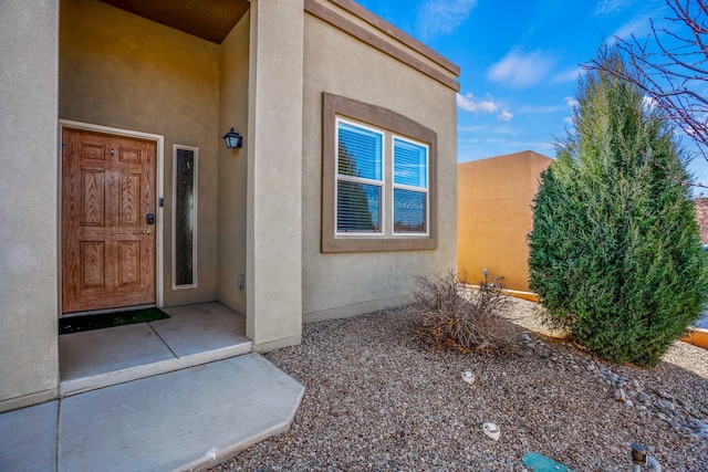 property entrance featuring stucco siding