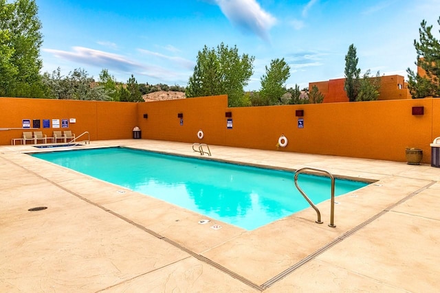 view of pool featuring a patio area and central air condition unit