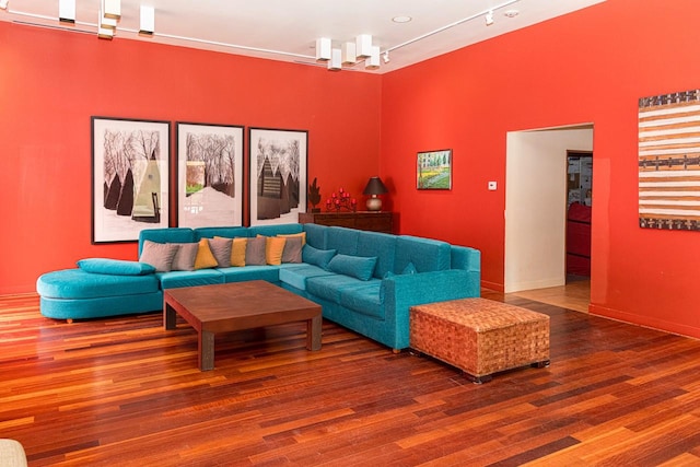 living room with wood-type flooring and track lighting