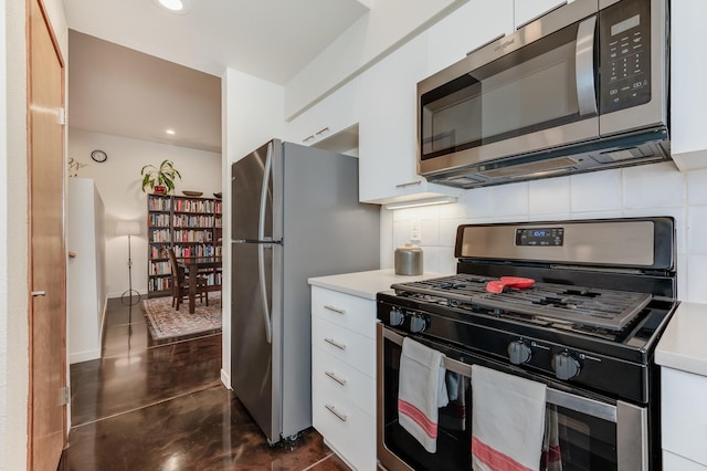 kitchen featuring white cabinets, decorative backsplash, and appliances with stainless steel finishes