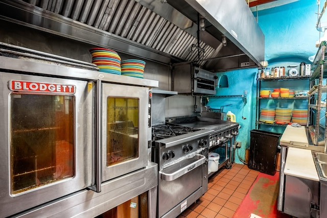 kitchen with tile patterned flooring and high end stove