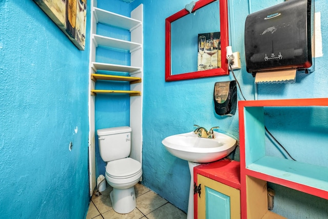 bathroom featuring tile patterned floors, toilet, and sink