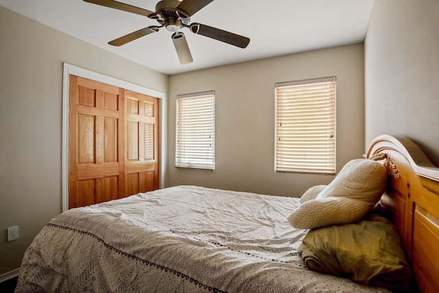 bedroom featuring ceiling fan and a closet