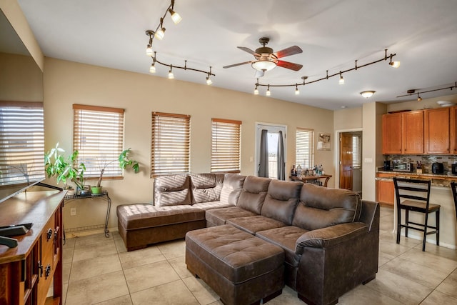 living room featuring ceiling fan and light tile patterned flooring