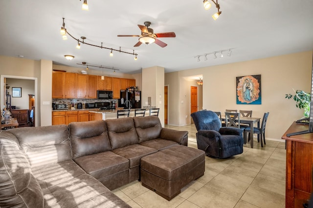 living room with light tile patterned floors and ceiling fan