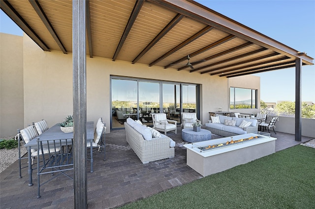view of patio featuring an outdoor living space with a fire pit and outdoor dining space