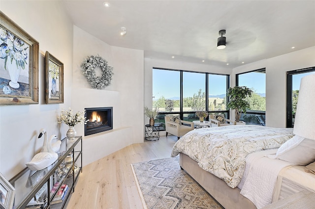 bedroom with light wood-type flooring and ceiling fan