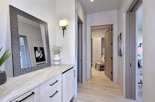 corridor with light hardwood / wood-style flooring