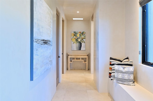 corridor with light tile patterned flooring