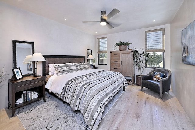 bedroom with wood finished floors, a ceiling fan, and recessed lighting