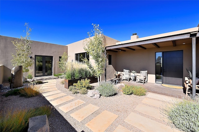 back of house featuring french doors and a patio