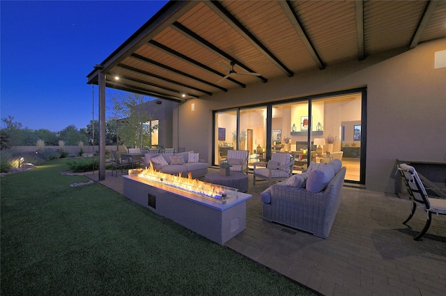 view of patio / terrace featuring an outdoor living space with a fire pit and a ceiling fan