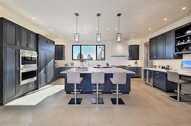 kitchen with stainless steel double oven, beverage cooler, decorative backsplash, open shelves, and recessed lighting