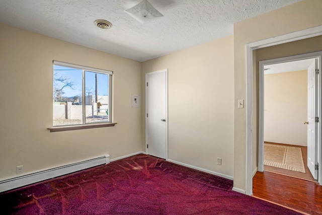 unfurnished room featuring carpet flooring, a baseboard radiator, and a textured ceiling