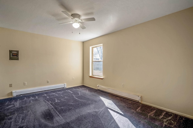 carpeted spare room featuring ceiling fan and a baseboard heating unit