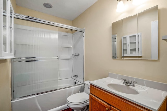 full bathroom featuring shower / bath combination with glass door, vanity, and toilet