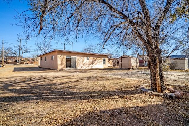 back of property featuring a shed