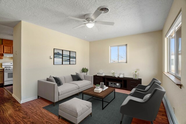 kitchen with a baseboard heating unit, sink, ceiling fan, stainless steel fridge, and extractor fan