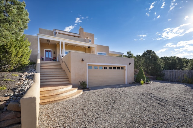 pueblo-style house featuring a garage