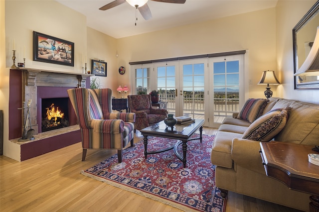 living room with wood-type flooring, french doors, and ceiling fan