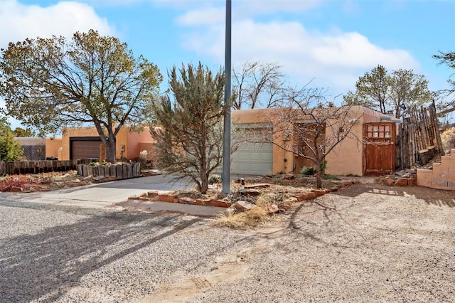 pueblo-style house with a garage