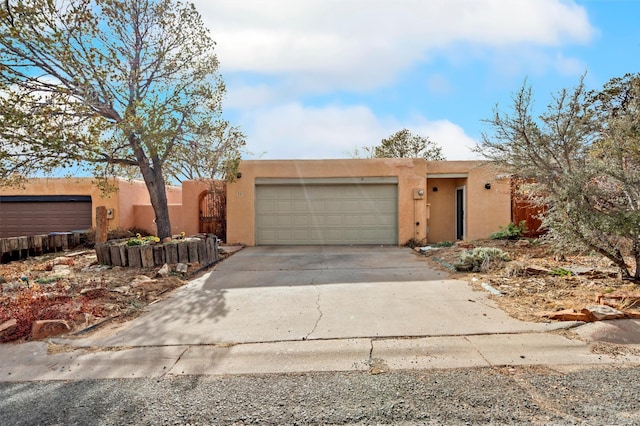 pueblo-style home featuring a garage