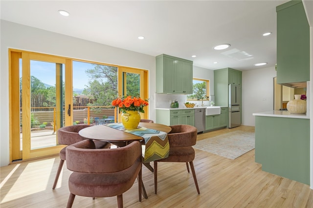 dining room featuring sink and light wood-type flooring