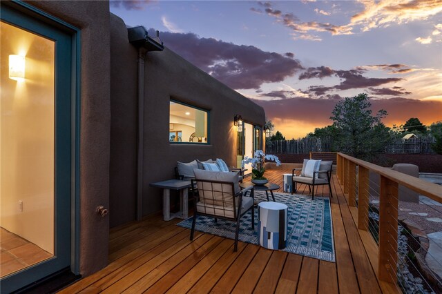 deck at dusk with outdoor lounge area