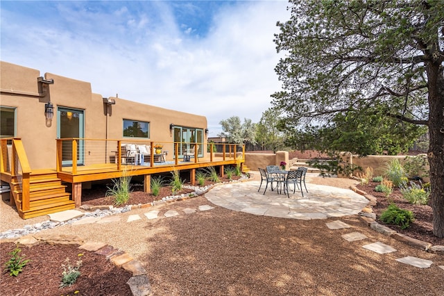 exterior space with a patio and a wooden deck