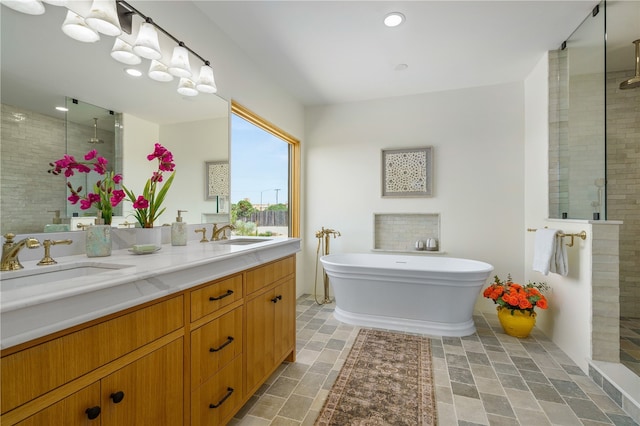 bathroom featuring vanity and shower with separate bathtub