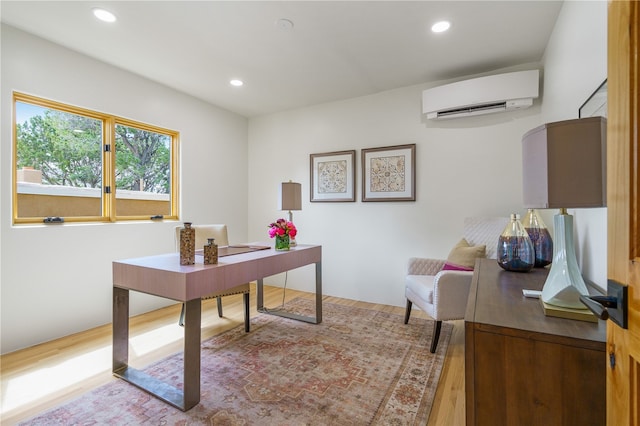 home office featuring a wall unit AC and wood-type flooring