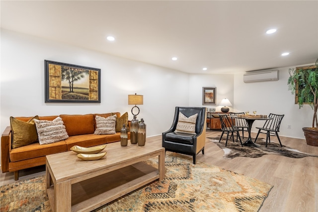 living room featuring an AC wall unit and hardwood / wood-style floors