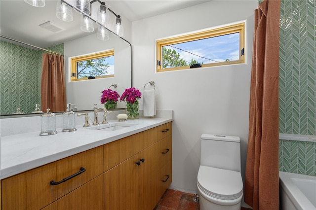 full bathroom featuring vanity, toilet, and shower / tub combo