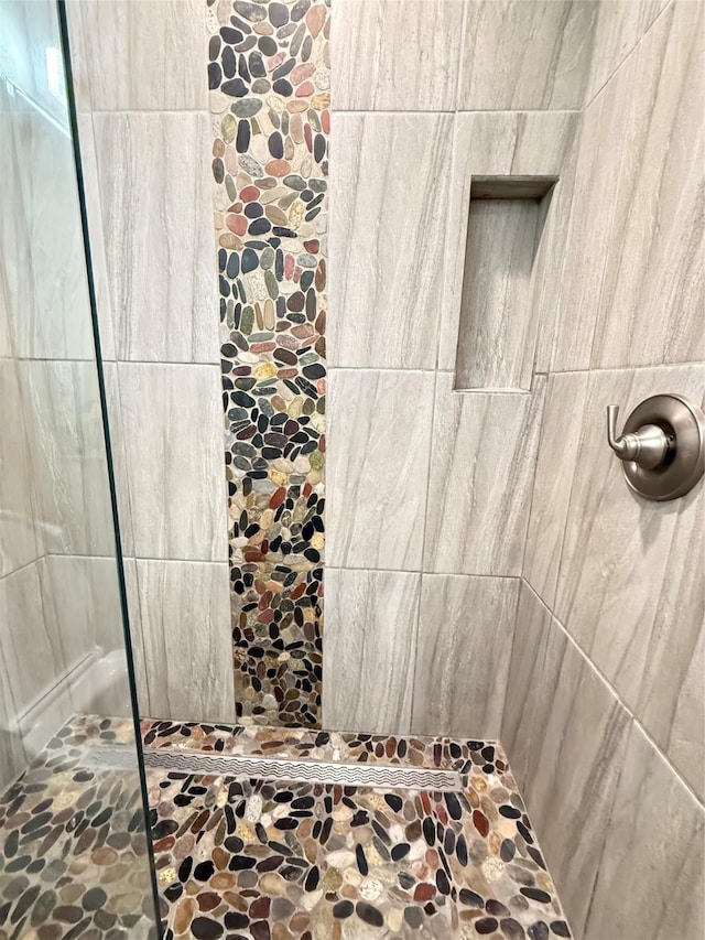 bathroom with a tile shower