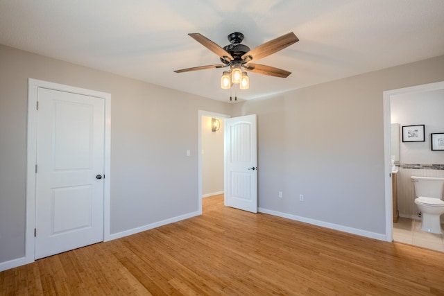 unfurnished bedroom featuring ceiling fan, light hardwood / wood-style floors, and ensuite bath