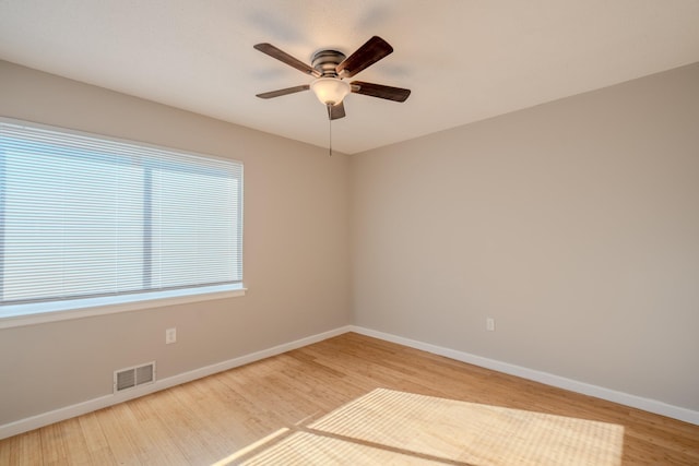 spare room featuring hardwood / wood-style floors and ceiling fan