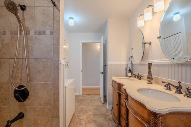 bathroom with tiled shower and vanity