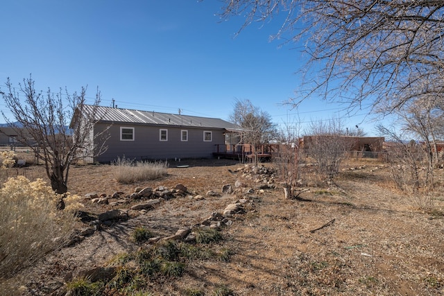 back of house with a wooden deck