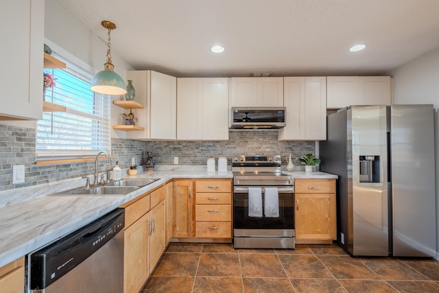 kitchen with sink, backsplash, decorative light fixtures, light brown cabinetry, and appliances with stainless steel finishes