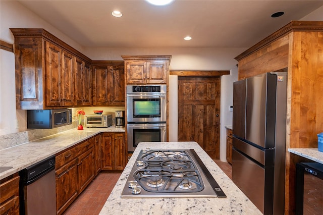 kitchen with appliances with stainless steel finishes, beverage cooler, and light stone counters