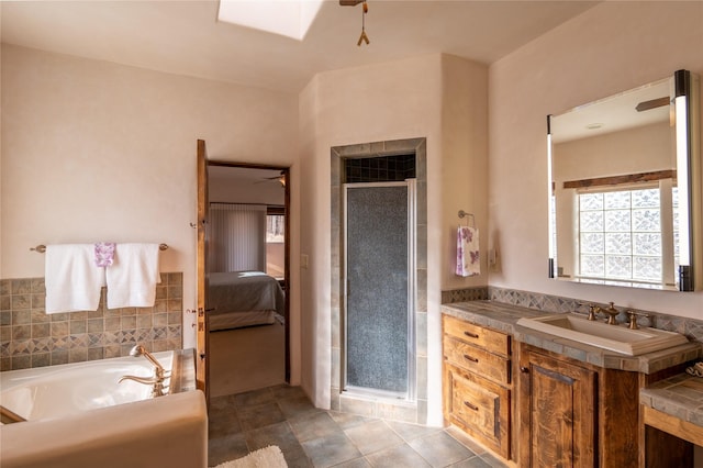 bathroom with ceiling fan, vanity, shower with separate bathtub, and tile patterned flooring