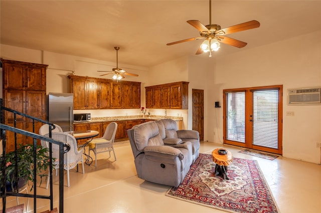 living room with ceiling fan and a wall mounted air conditioner