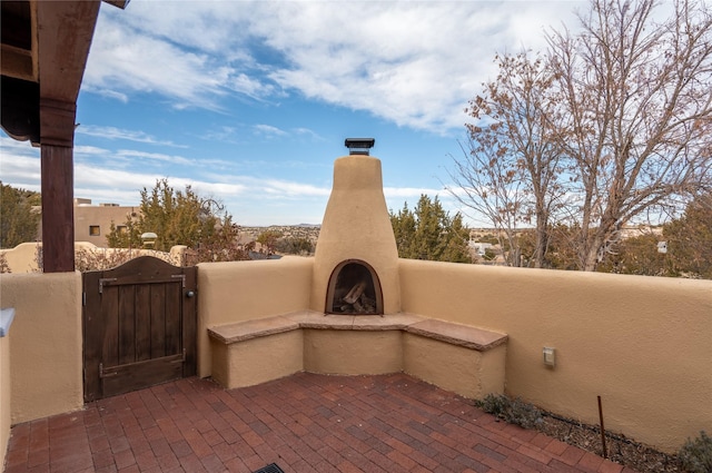 view of patio featuring exterior fireplace