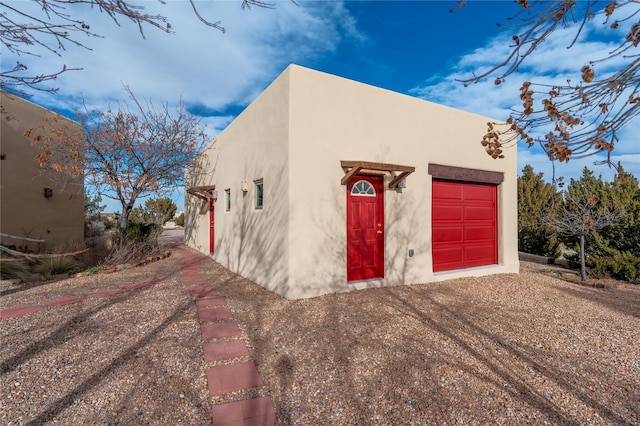 view of front facade with a garage and an outbuilding