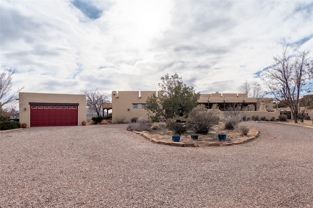 pueblo-style home featuring a garage