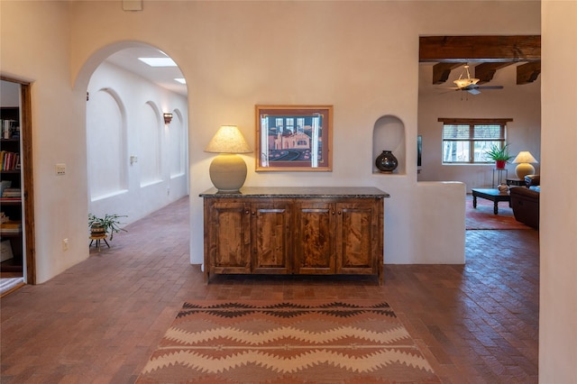 corridor featuring beam ceiling