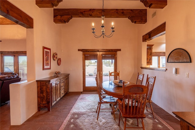 dining space featuring an inviting chandelier, french doors, and a healthy amount of sunlight